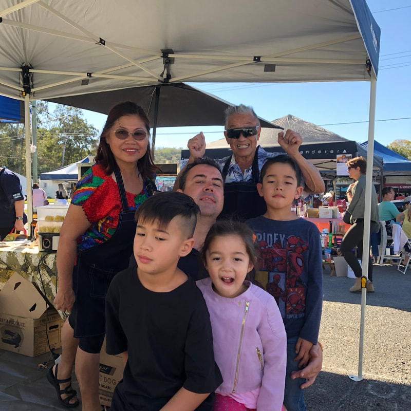 A picture of Mie Mie, Willie, Tim (Angela's Husband), Noah, Moses and Halle at the Salisbury Market, the first Mamaku Stall